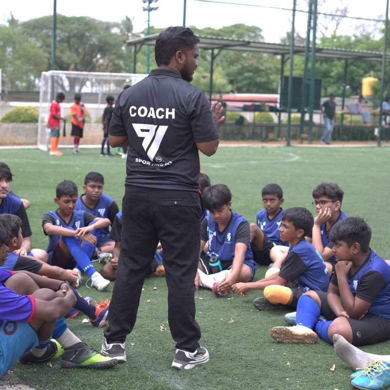 A coach briefing players before a session