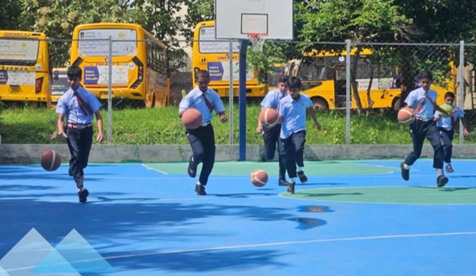 School students playing basketball on an outdoor court