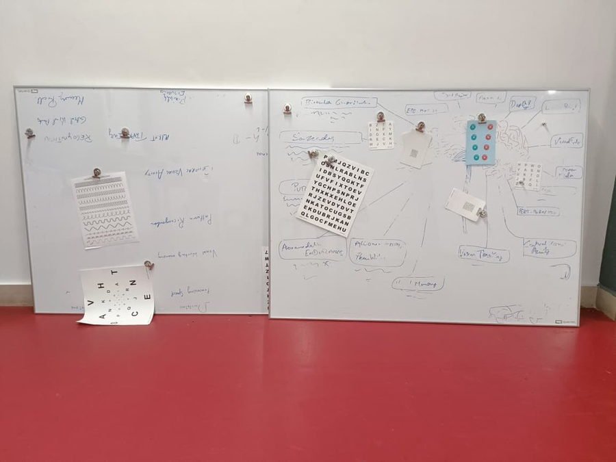 Reaction and vision drills pinned to whiteboards in the lab