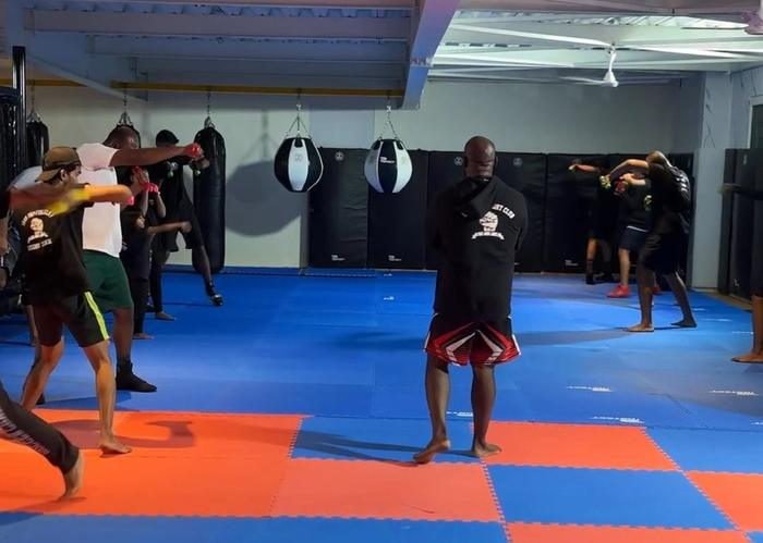 A martial arts session in progress on the matted training floor